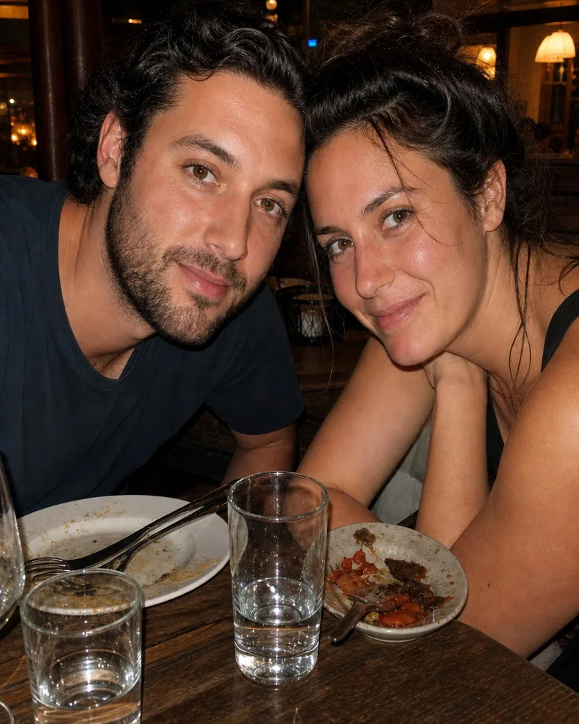 The same dinner photo with the flash shine and red flush calmed, the sauce smear gone, and the warm restaurant light and tired-eyed grins kept