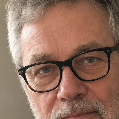 Close crop of the profile picture at 100%, showing the same pores, lines, and skin tone as the upload